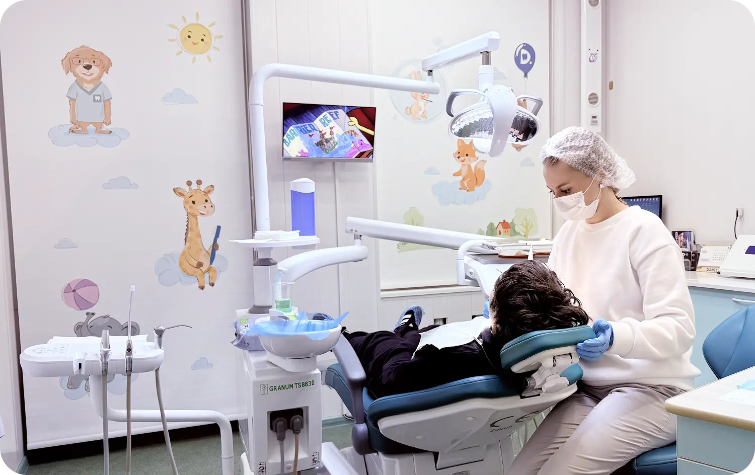 Врач во время лечения кариеса у детей